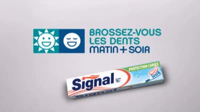 A tube of toothpaste with a slogan in French above reading Brossez-vous les dents matin et soir